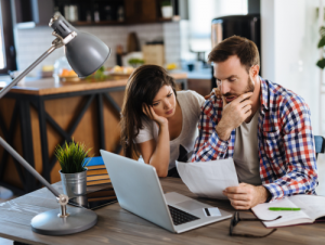 Man and women stressed looking at a large medical bill