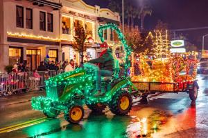 A green John Deere tractor pulls a wagon past the Mount View Hotel in Calistoga.