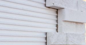 Close up of white stone pieces installed on a Stone Panel+ EPS insulated foam panel with molded alignment channels.