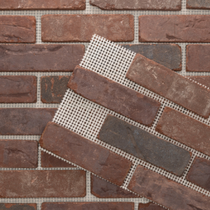 Close-up of Brickwebb thin brick sheets with kiln-fired clay bricks mounted on a fiberglass mesh for easy, pre-spaced installation.