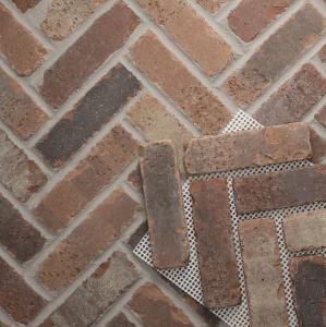 Close-up of Brickwebb Herringbone thin brick sheets with pre-spaced clay bricks attached to a mesh backing for fast and accurate herringbone installation.