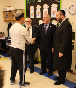 Dr. Joshua Weinstein (left), Assemblyman Steven Cymbrowitz (middle), Mr. Ezra Freidlander (right) meeting students at SKHOV