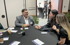 Dr. Benjamin Clinton, Founder of Beacon Administrative Consulting, speaks with UTRGV Career Bridge students during the RGV LEAD Showcase, seated around a conference table discussing leadership and workforce development.