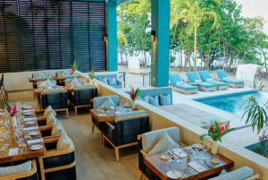 View of dining room with view of pool and Caribbean Sea