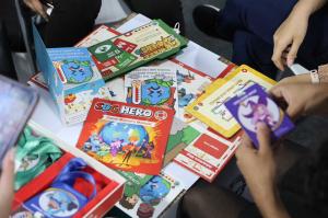 Participants experiencing "SDG Hero" – in the scene, they are flipping through related cards.